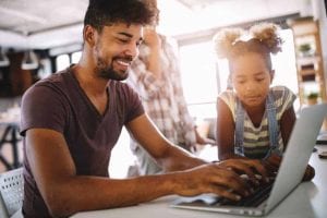 Father and Daughter using laptop on WiFi